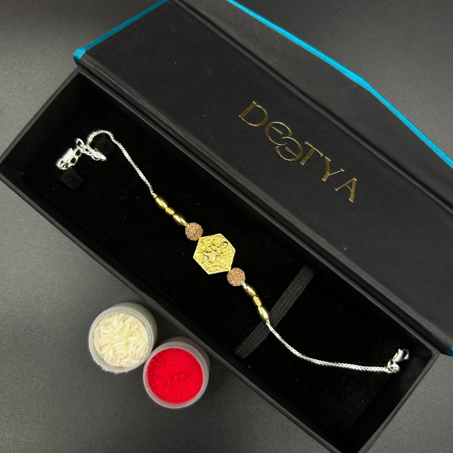 Yellow Gold Ganpati Rakhi with Rudraksh