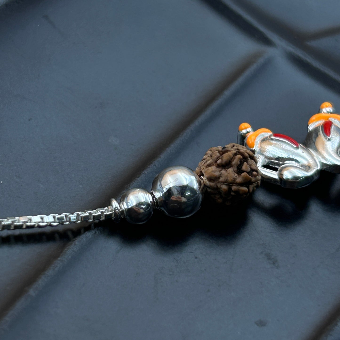 Silver Ganesh Rakhi with Rudraksh