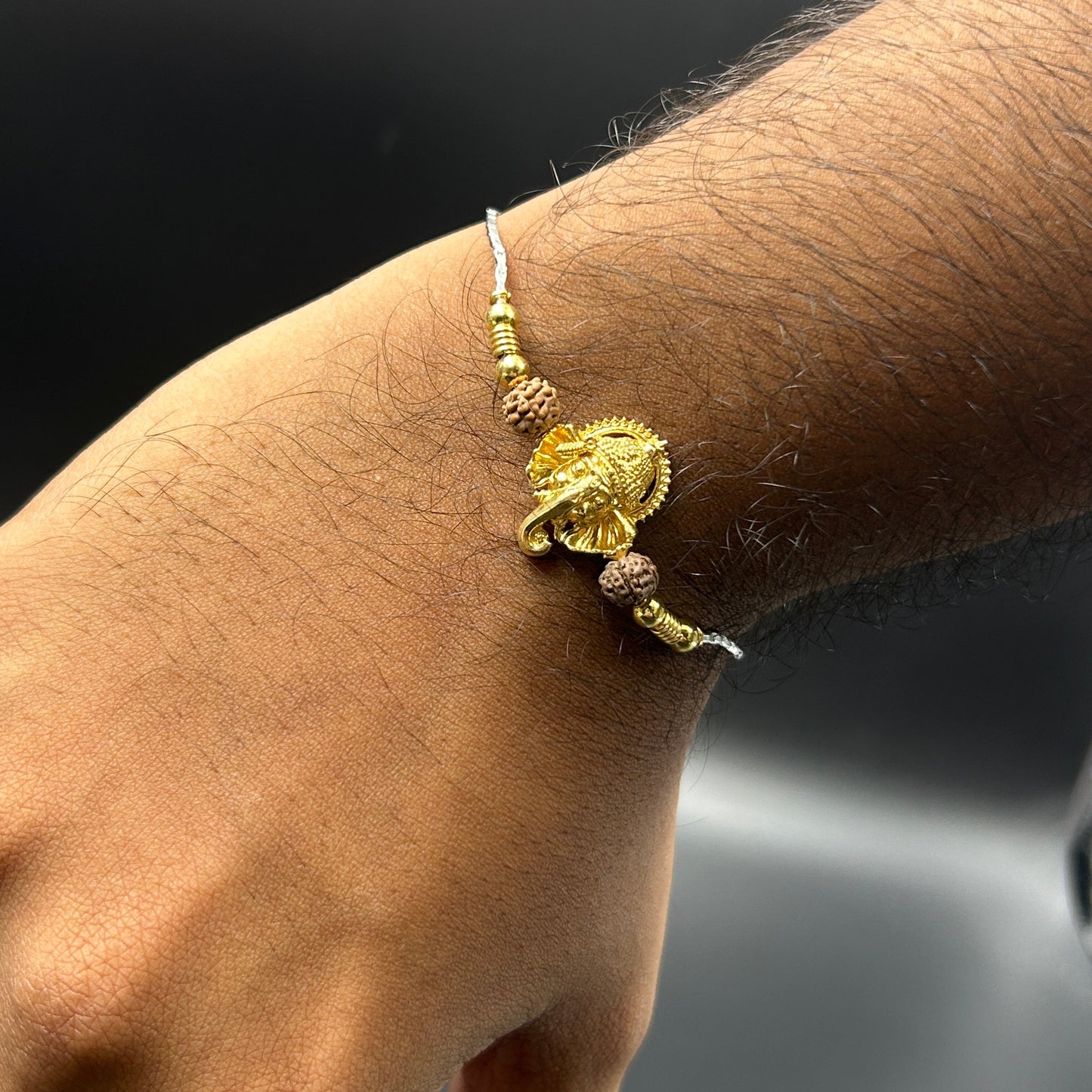 Yellow Gold Ganesh Rakhi with Rudraksh