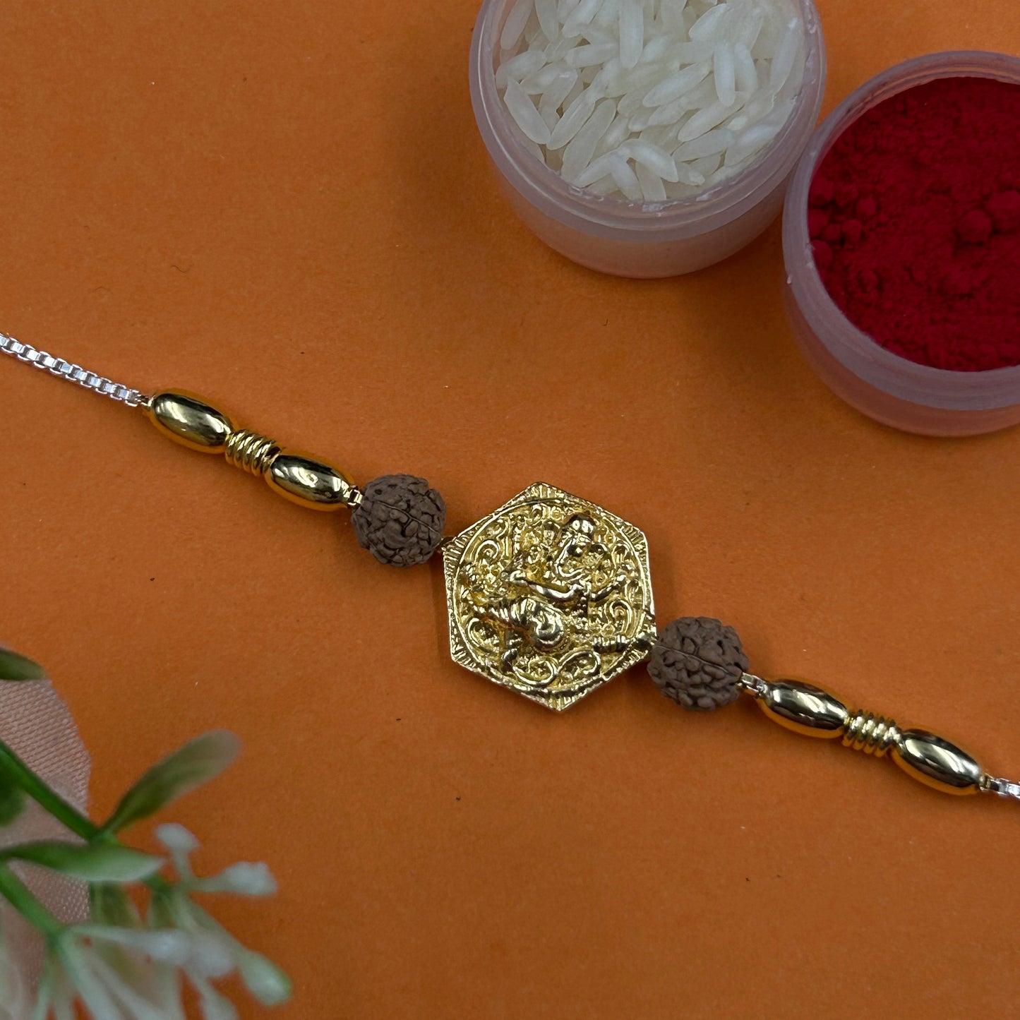 Yellow Gold Ganpati Rakhi with Rudraksh