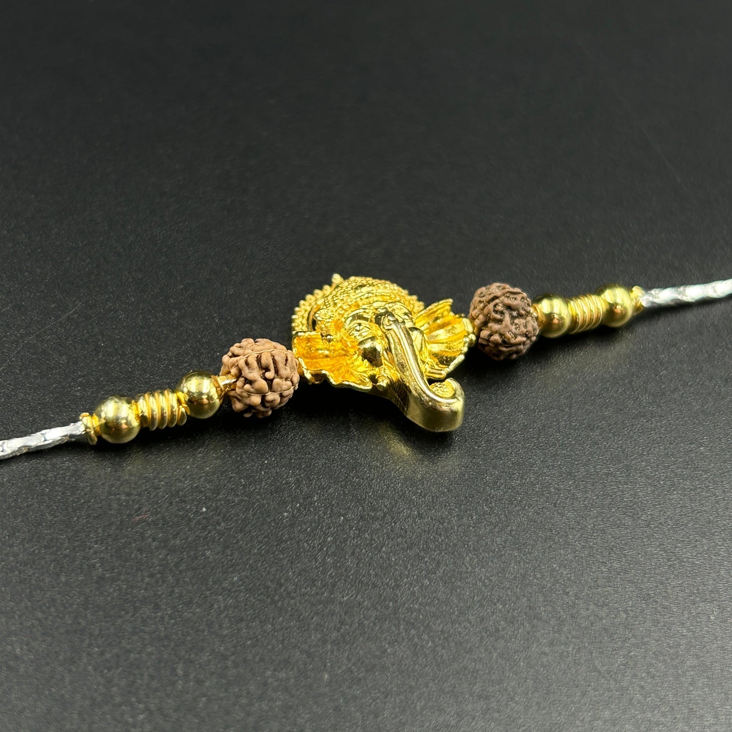 Yellow Gold Ganesh Rakhi with Rudraksh